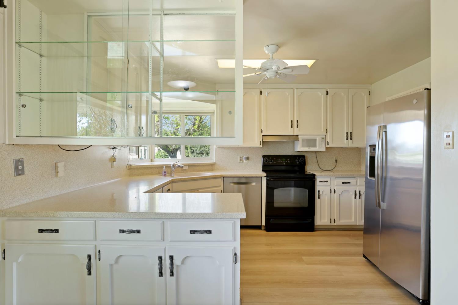 2465 Vernalis Road Tracy, CA 95304 - Photo 6 of 55 a kitchen with a refrigerator sink and cabinets