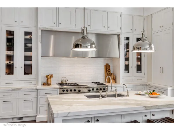 a kitchen with a stove and a wooden floor