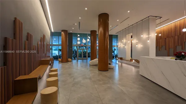 a lobby with furniture and a glass door
