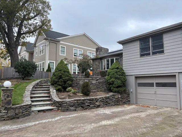 a front view of a house with garden