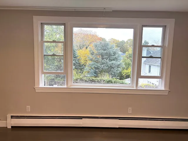 a view of a room with a window and a ceiling fan