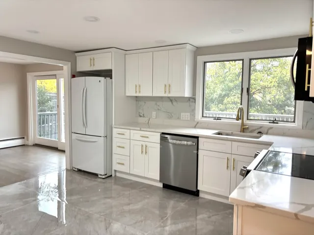 a kitchen with a refrigerator and a sink