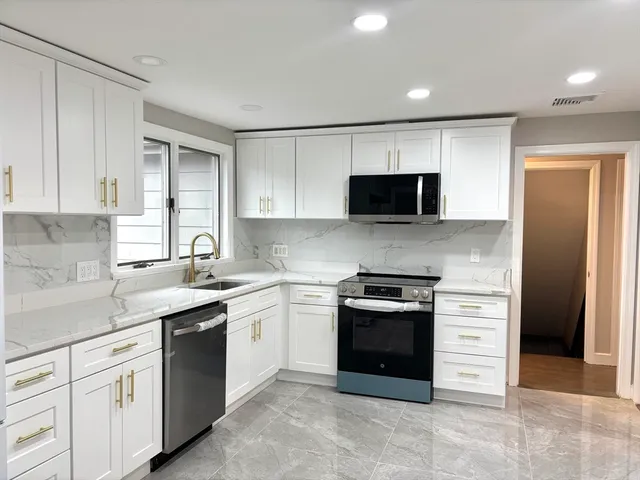 a kitchen with a sink and a stove top oven