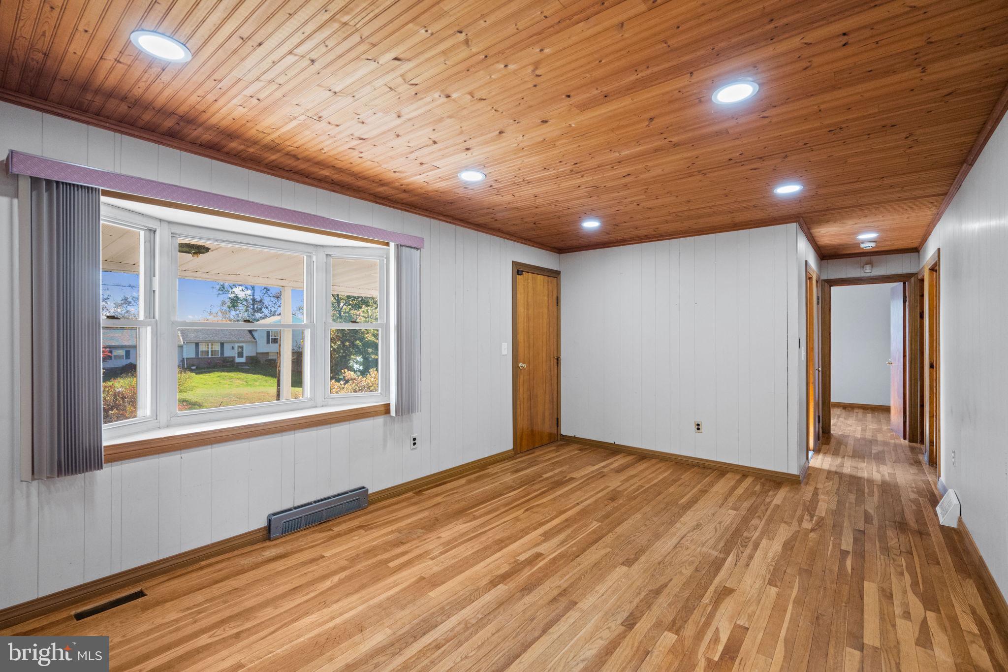 3744 Back Woods Road Westminster, MD 21158 - Photo 12 of 62 a view of an empty room with wooden floor and a window