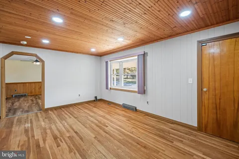 a kitchen with a refrigerator cabinets and wooden floor