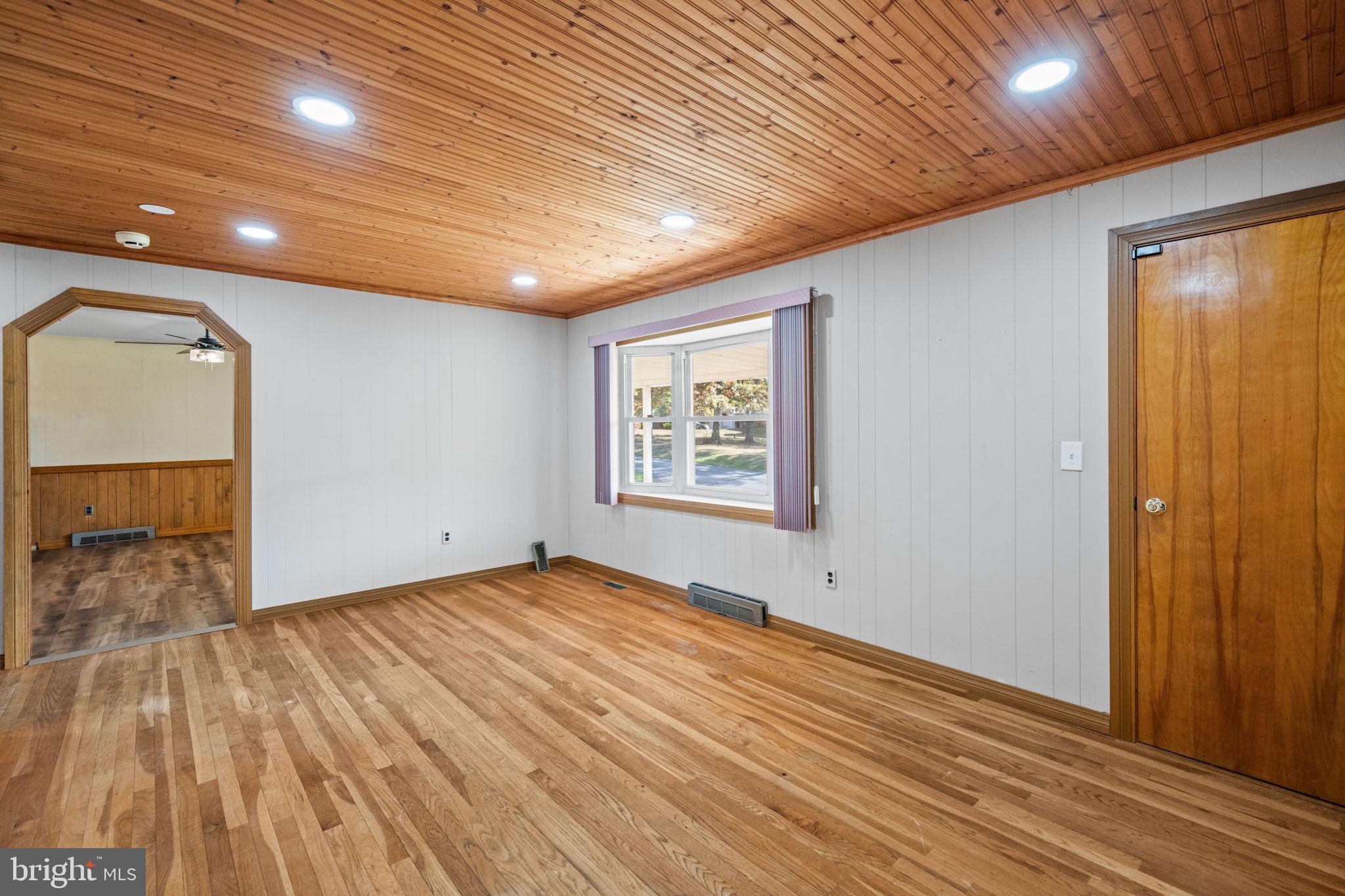 3744 Back Woods Road Westminster, MD 21158 - Photo 14 of 62 a view of an empty room with wooden floor and a window