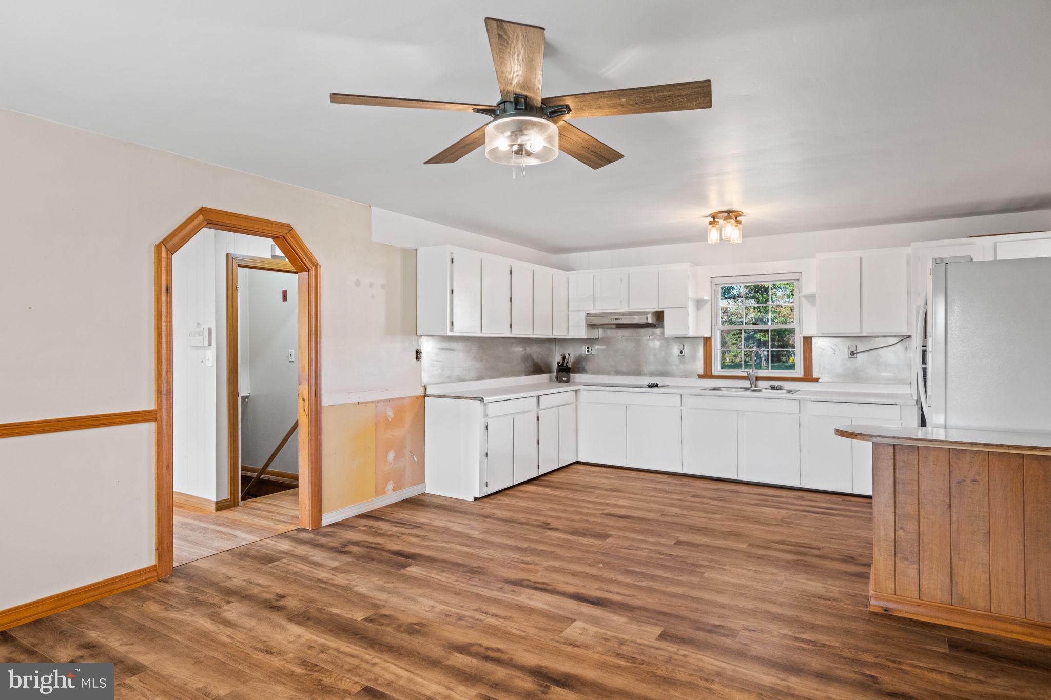 3744 Back Woods Road Westminster, MD 21158 - Photo 17 of 62 a kitchen with a refrigerator cabinets and wooden floor