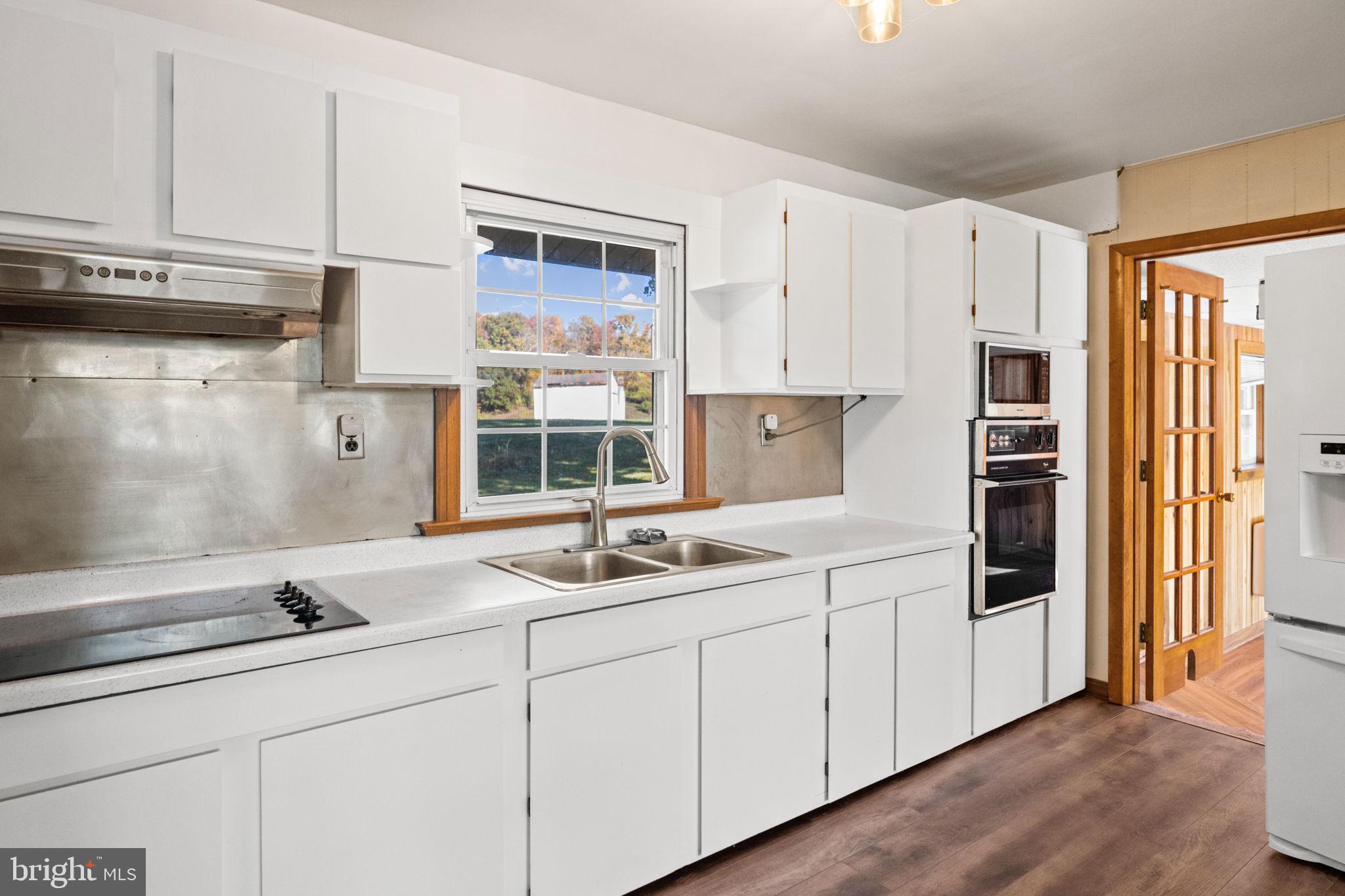 3744 Back Woods Road Westminster, MD 21158 - Photo 18 of 62 a kitchen with stainless steel appliances sink and cabinets