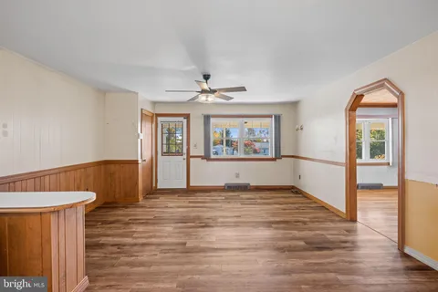 a view of a bathroom with mirror and shower