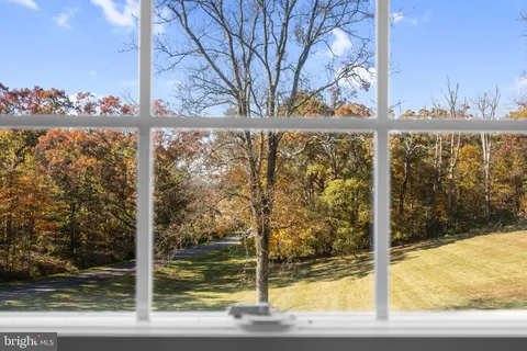 a view of a room with wooden floor and window