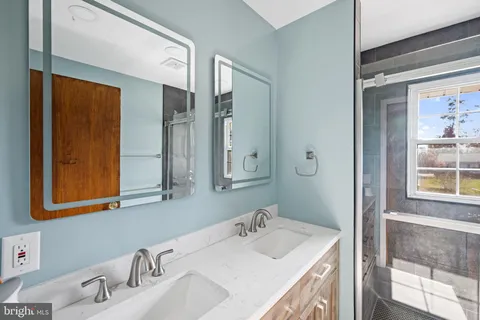 an empty room with closet and windows