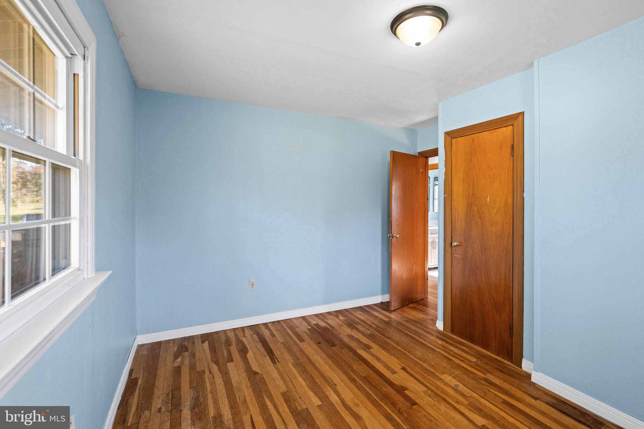 3744 Back Woods Road Westminster, MD 21158 - Photo 33 of 62 a view of an empty room with wooden floor and a window