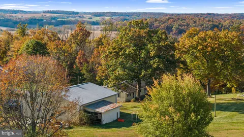 a front view of a house with a yard table and chairs