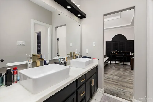 a bathroom with a sink double vanity and a mirror