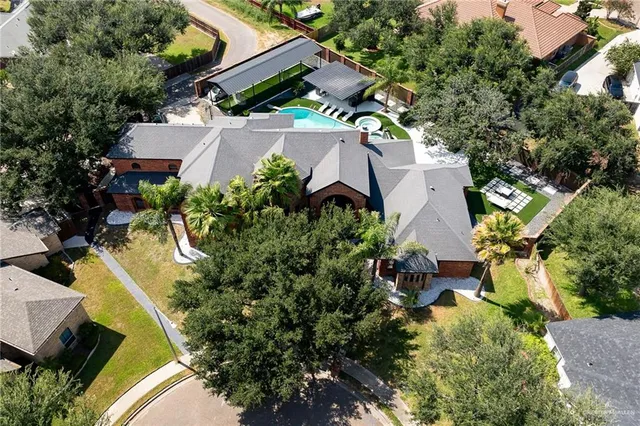 an aerial view of a house with a yard and trees