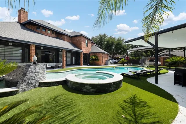 a swimming pool with outdoor seating yard and barbeque oven