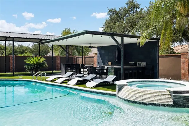 a view of a swimming pool with a patio