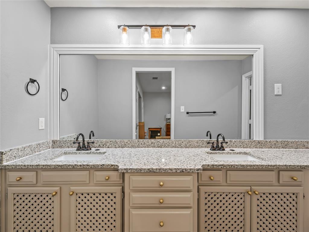 153 Meadowcreek Road Coppell, TX 75019 - Photo 20 of 35 a bathroom with a granite countertop sink and a mirror