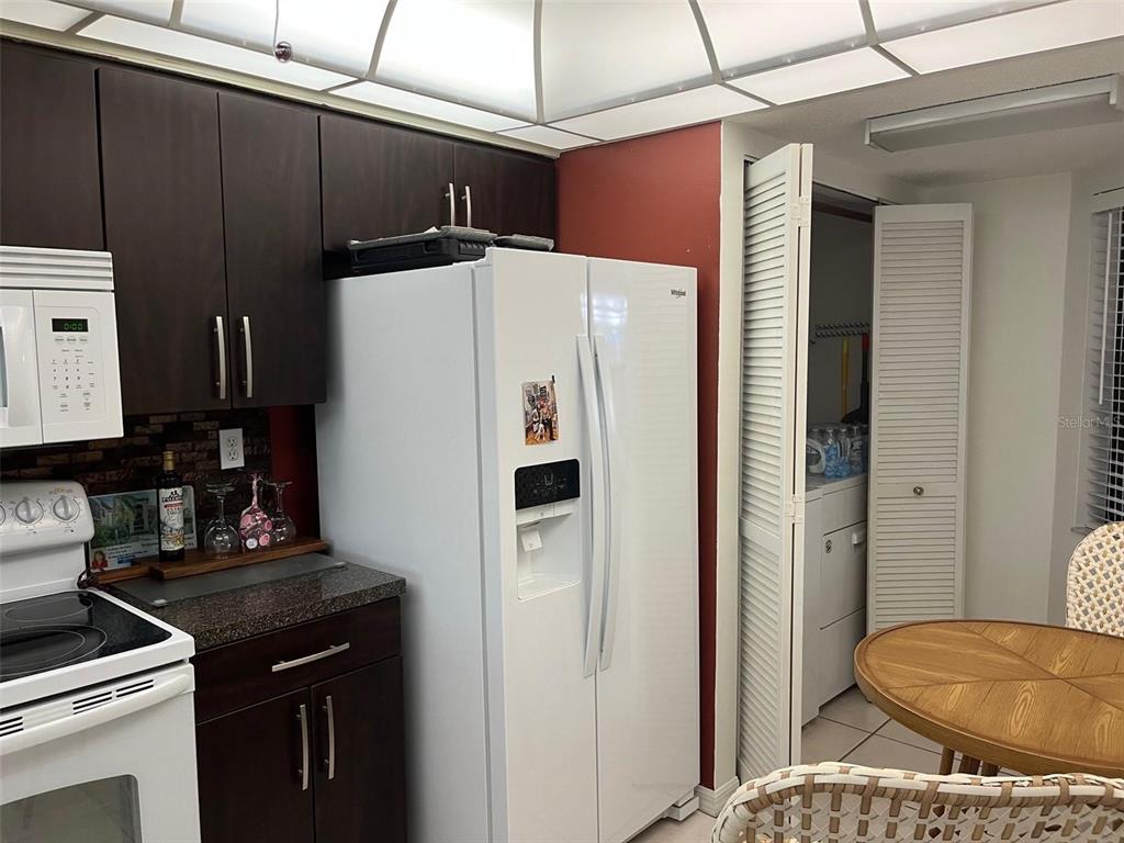 23465 Harbor View Road, Unit 1006 Punta Gorda, FL 33980 - Photo 14 of 41 a white refrigerator freezer sitting inside of a kitchen
