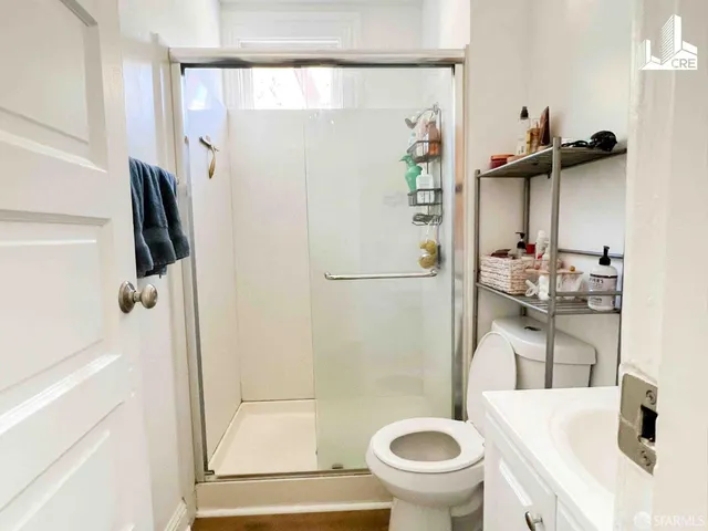 a bathroom with a shower and a toilet