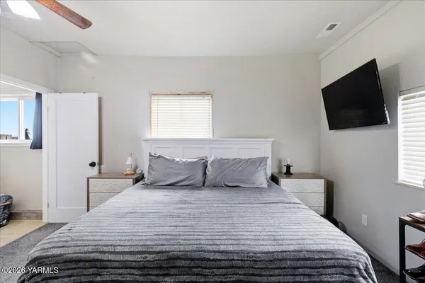 a bedroom with a large bed and a window