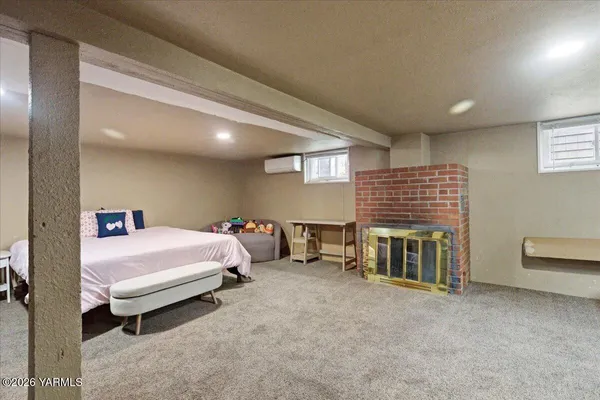 a bedroom with furniture and a flat tv screen