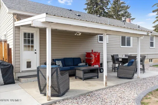 a view of a patio with dining table and chairs with wooden floor