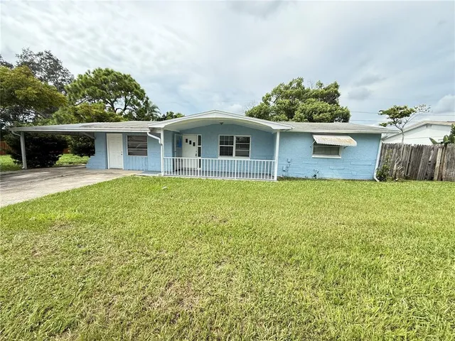 a front view of a house with yard and green space