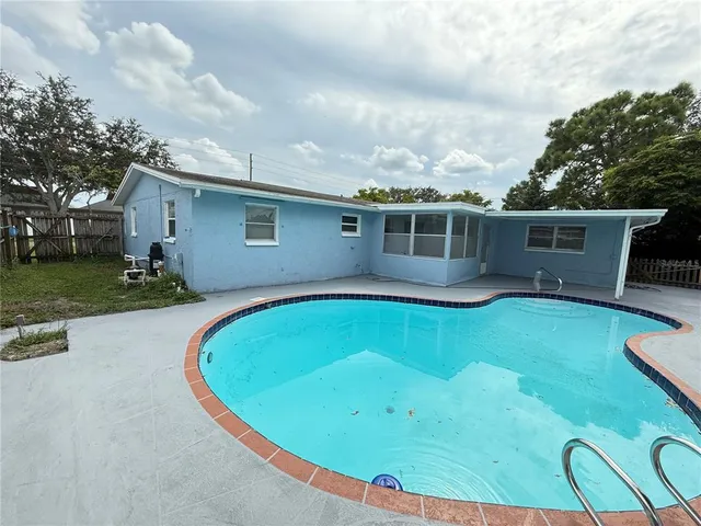 a view of a swimming pool with a yard