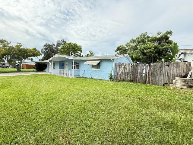 a view of a house with a yard and sitting area