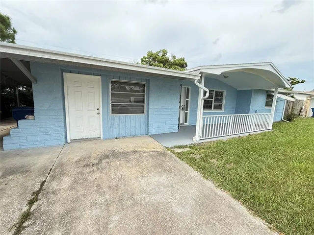 a view of a house with a backyard and garage