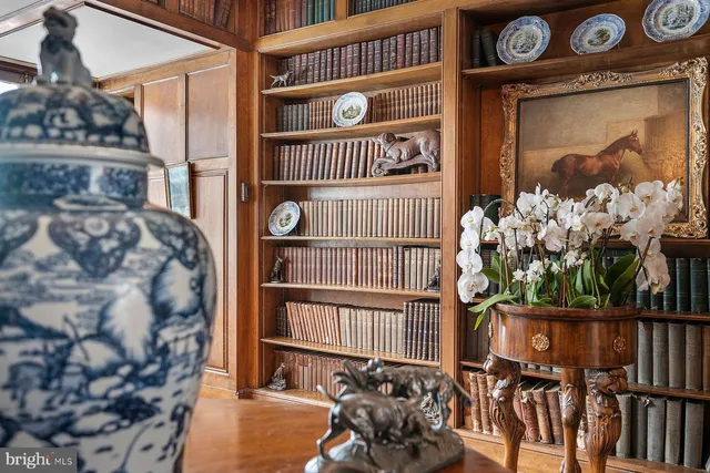 a large white kitchen with wooden floor and a sink