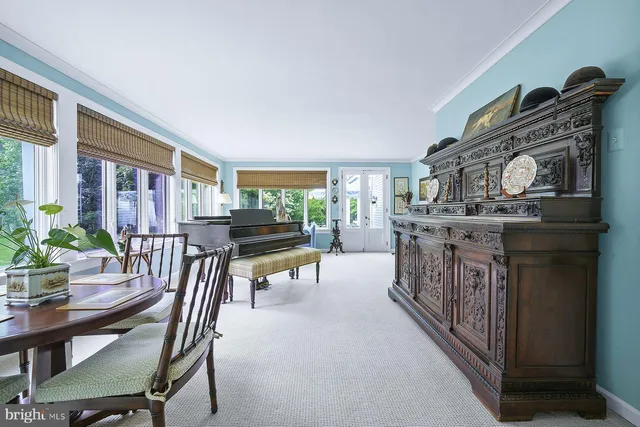 a view of a dining room with furniture and a window