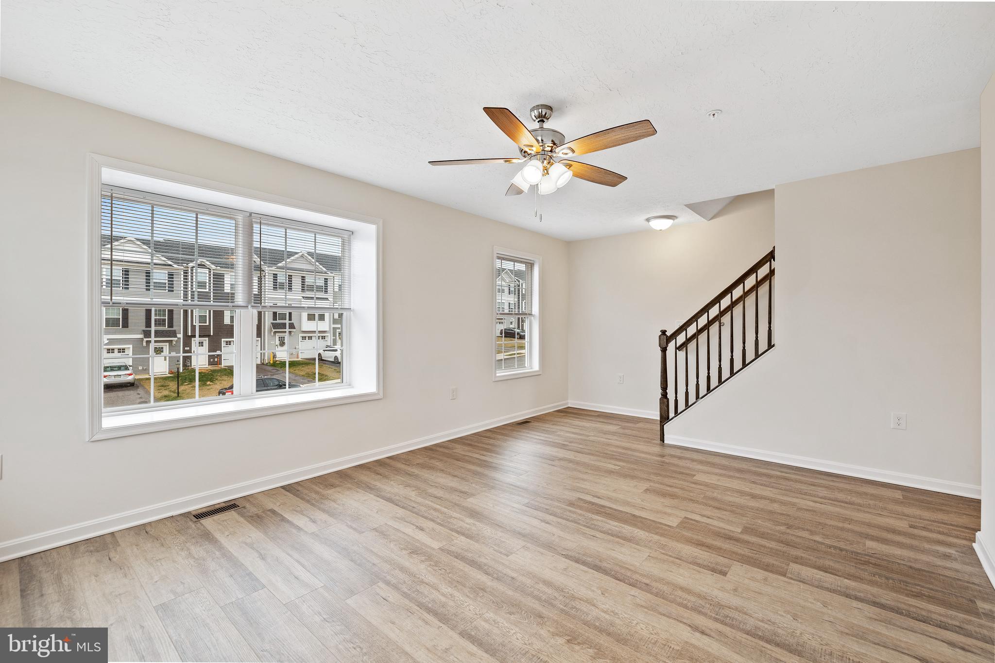 495 South Spring Garden Street, Unit 107 Carlisle, PA 17013 - Photo 12 of 26 a view of an empty room with a window and wooden floor