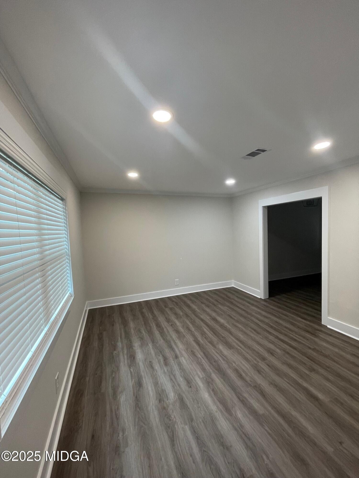2375 Parker Avenue, Unit 2 Macon, GA 31204 - Photo 11 of 16 a view of an empty room with wooden floor and a window