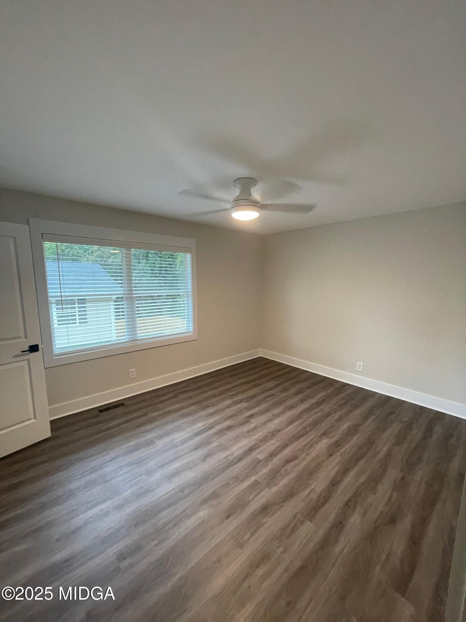 2375 Parker Avenue, Unit 2 Macon, GA 31204 - Photo 13 of 16 an empty room with wooden floor and windows