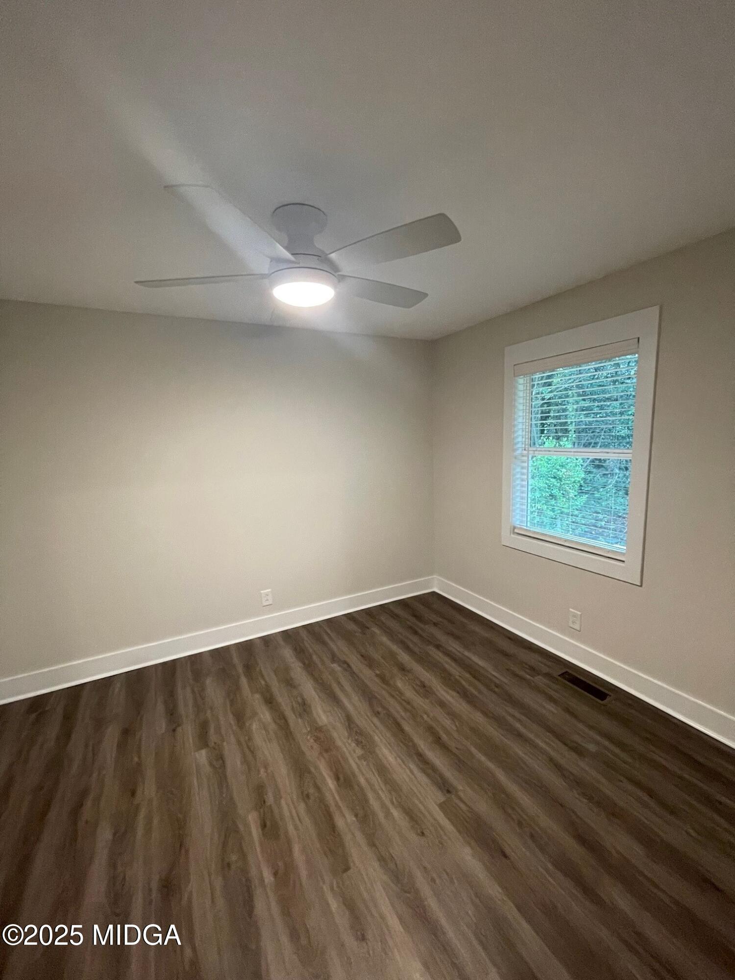 2375 Parker Avenue, Unit 2 Macon, GA 31204 - Photo 14 of 16 an empty room with wooden floor and windows