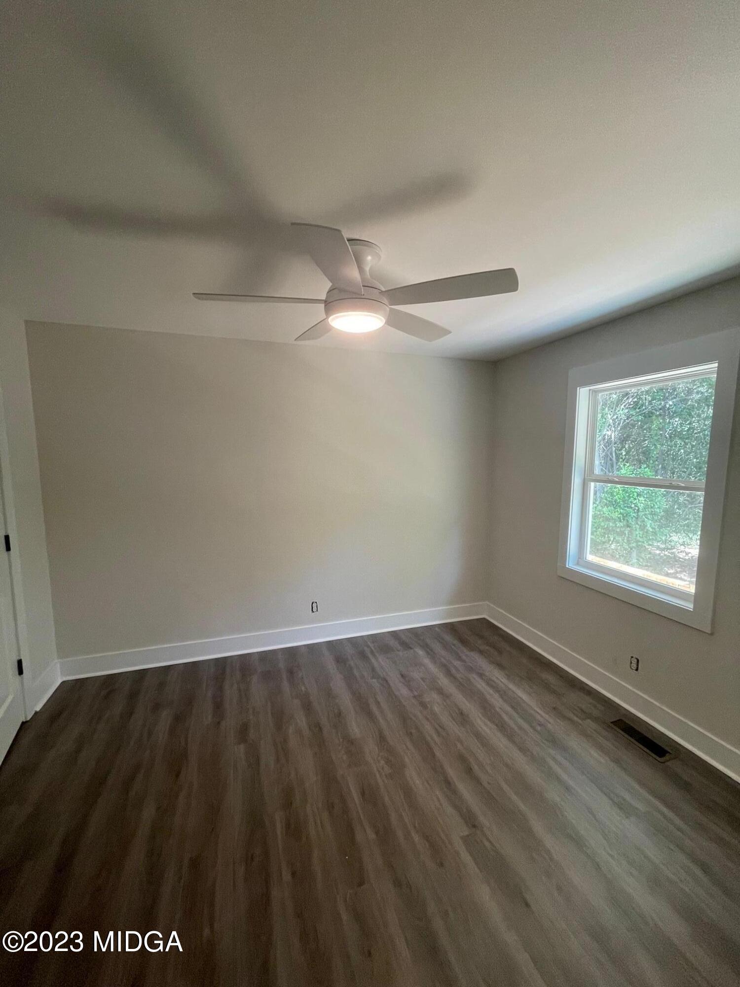 2375 Parker Avenue, Unit 2 Macon, GA 31204 - Photo 5 of 16 an empty room with wooden floor and windows