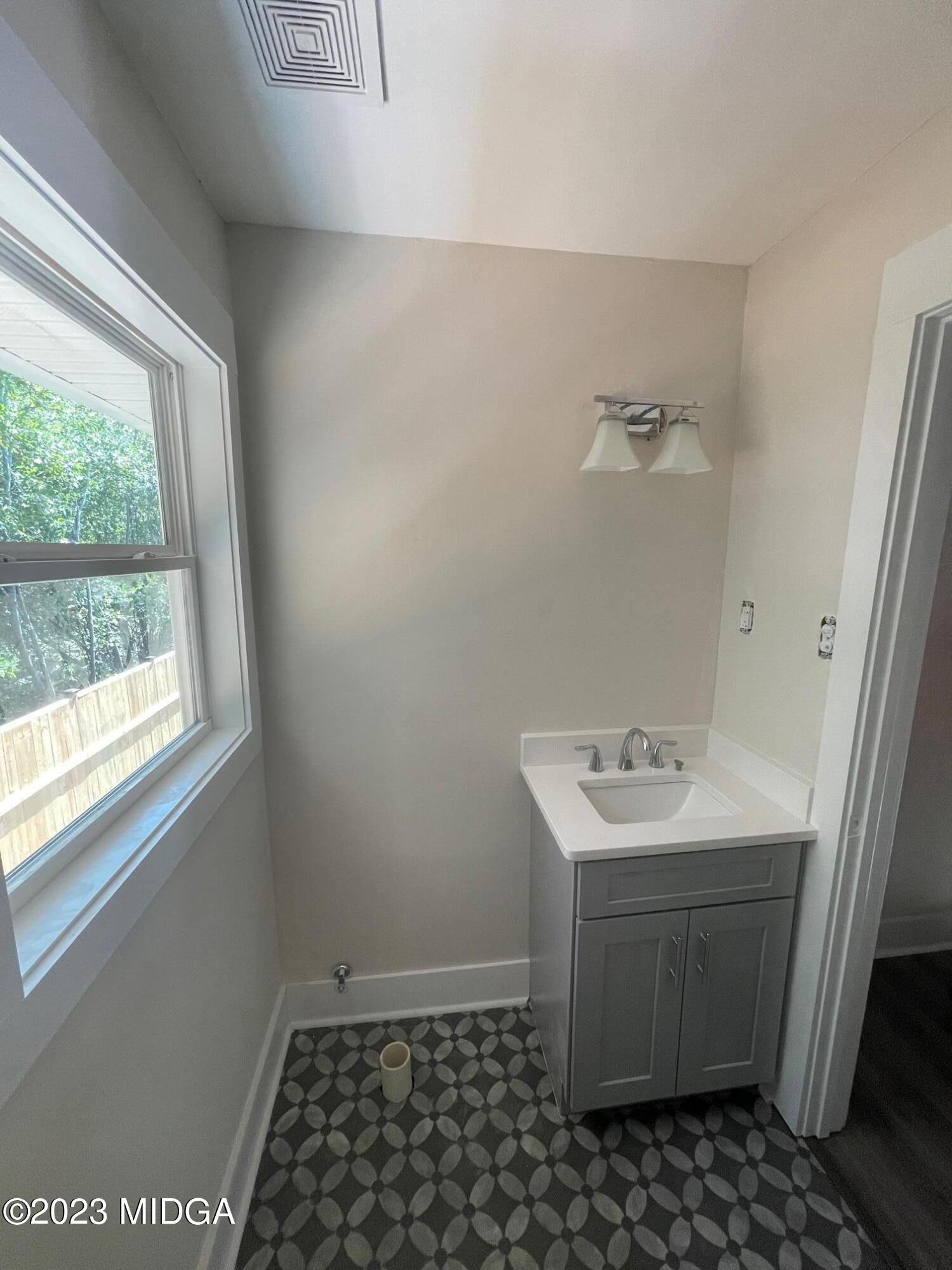2375 Parker Avenue, Unit 2 Macon, GA 31204 - Photo 6 of 16 a bathroom with a sink toilet and window