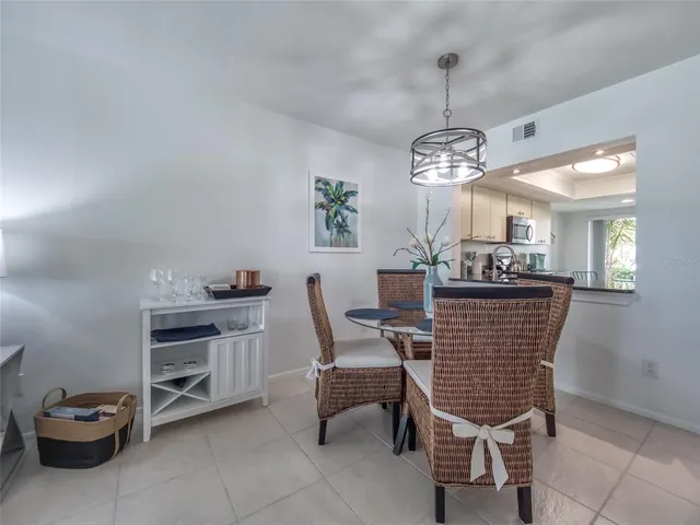 a dining room with a furniture and kitchen view