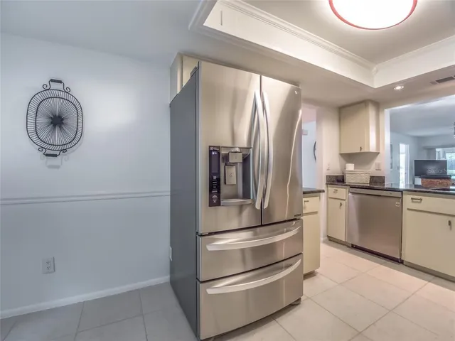 a kitchen with a refrigerator and cabinets