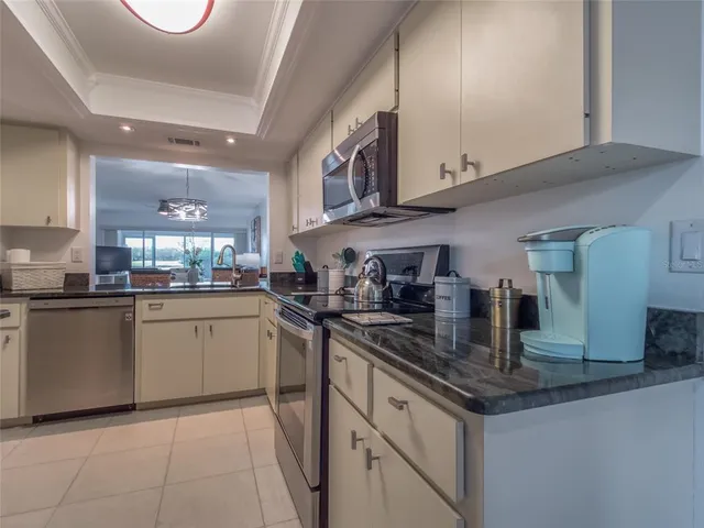 a kitchen with stainless steel appliances granite countertop a sink and cabinets