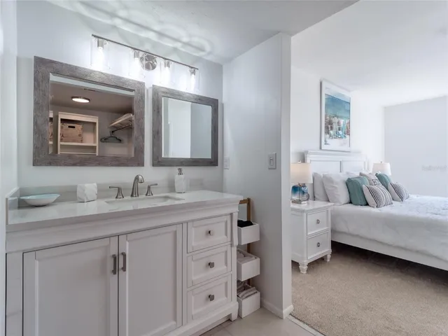 a en suite bathroom with a double vanity sink and a mirror