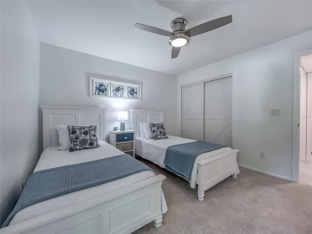 a bedroom with double bed and a chandelier