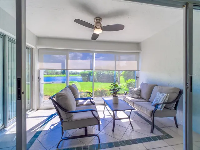 a dining room with furniture and a large window