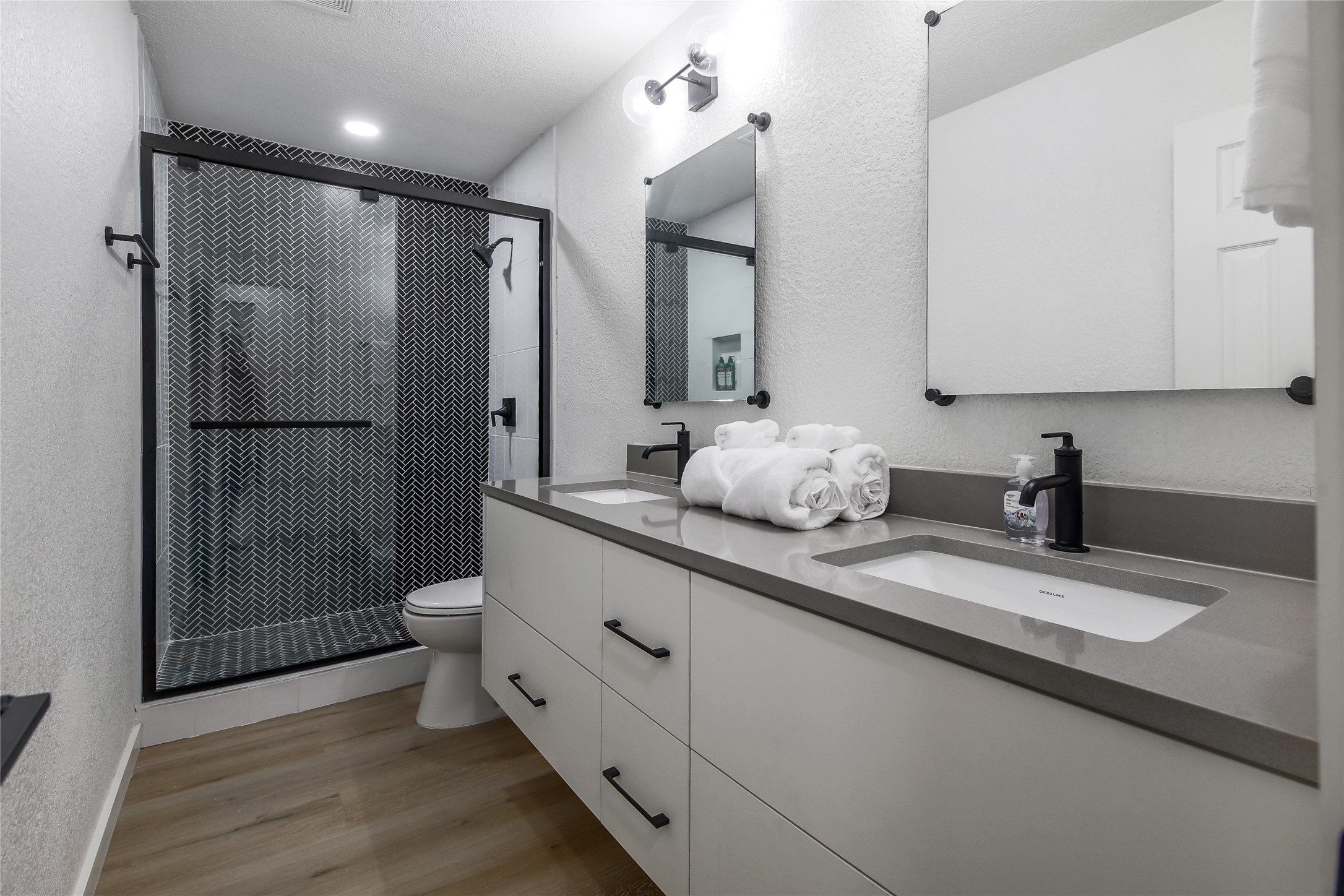 10509 Macmora Road, Unit B Austin, TX 78758 - Photo 10 of 19 a bathroom with double vanity and a shower