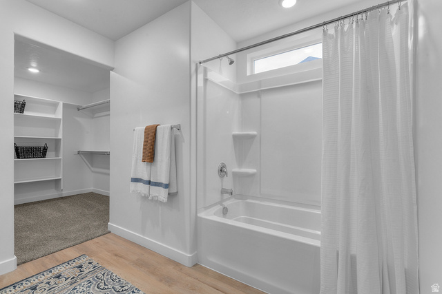 722 West 2840 South, Unit 8 Logan, UT 84321 - Photo 23 of 23 Bathroom featuring light wood finished floors, a spacious closet, recessed lighting, and shower / tub combo with curtain