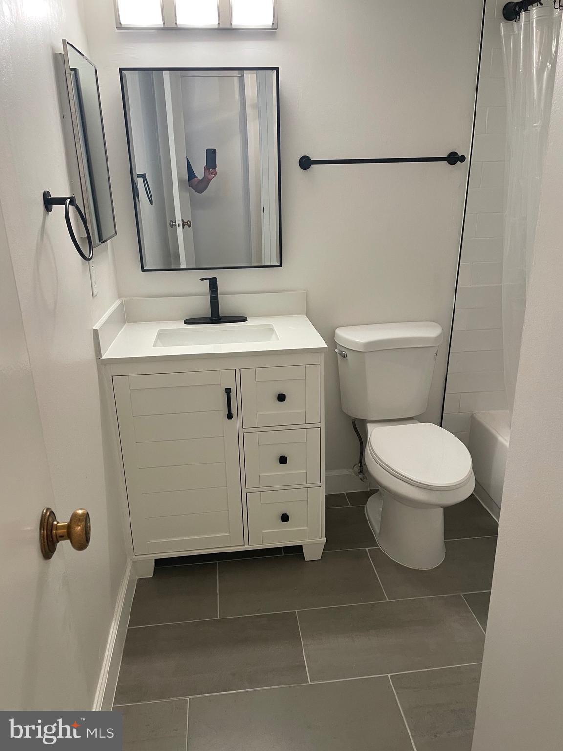11837 Shire Court, Unit 22 Reston, VA 20191 - Photo 12 of 14 a bathroom with a toilet sink and mirror