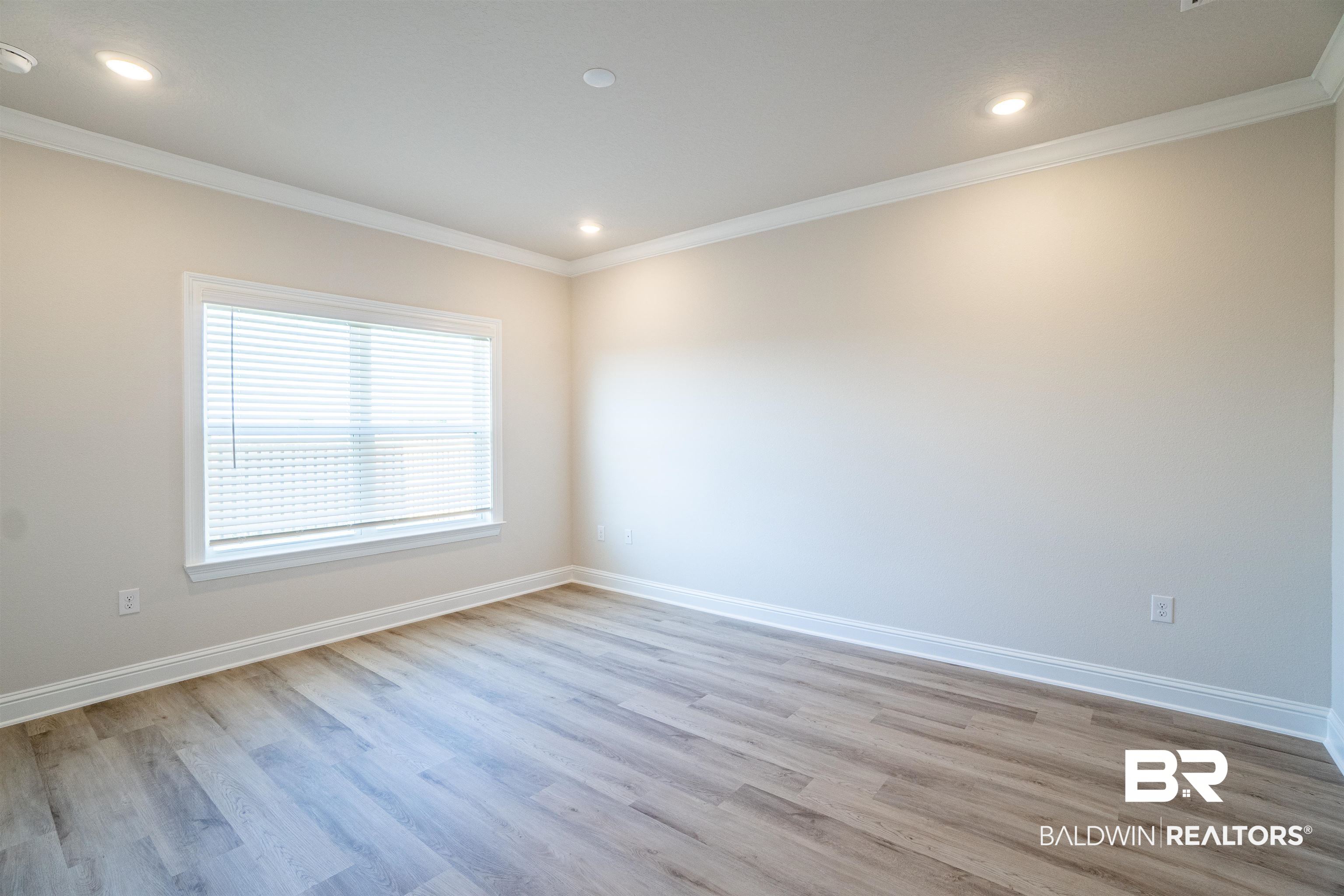 1073 Hayward Loop Foley, AL 36535 - Photo 10 of 18 Spacious room featuring wood-finish flooring, recessed lighting, crown molding, and a window with blinds