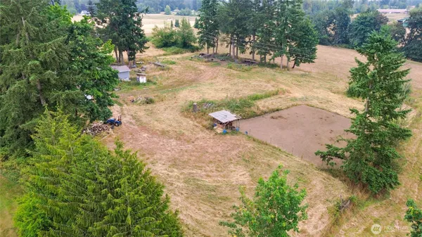 an aerial view of a house with a yard and lake view